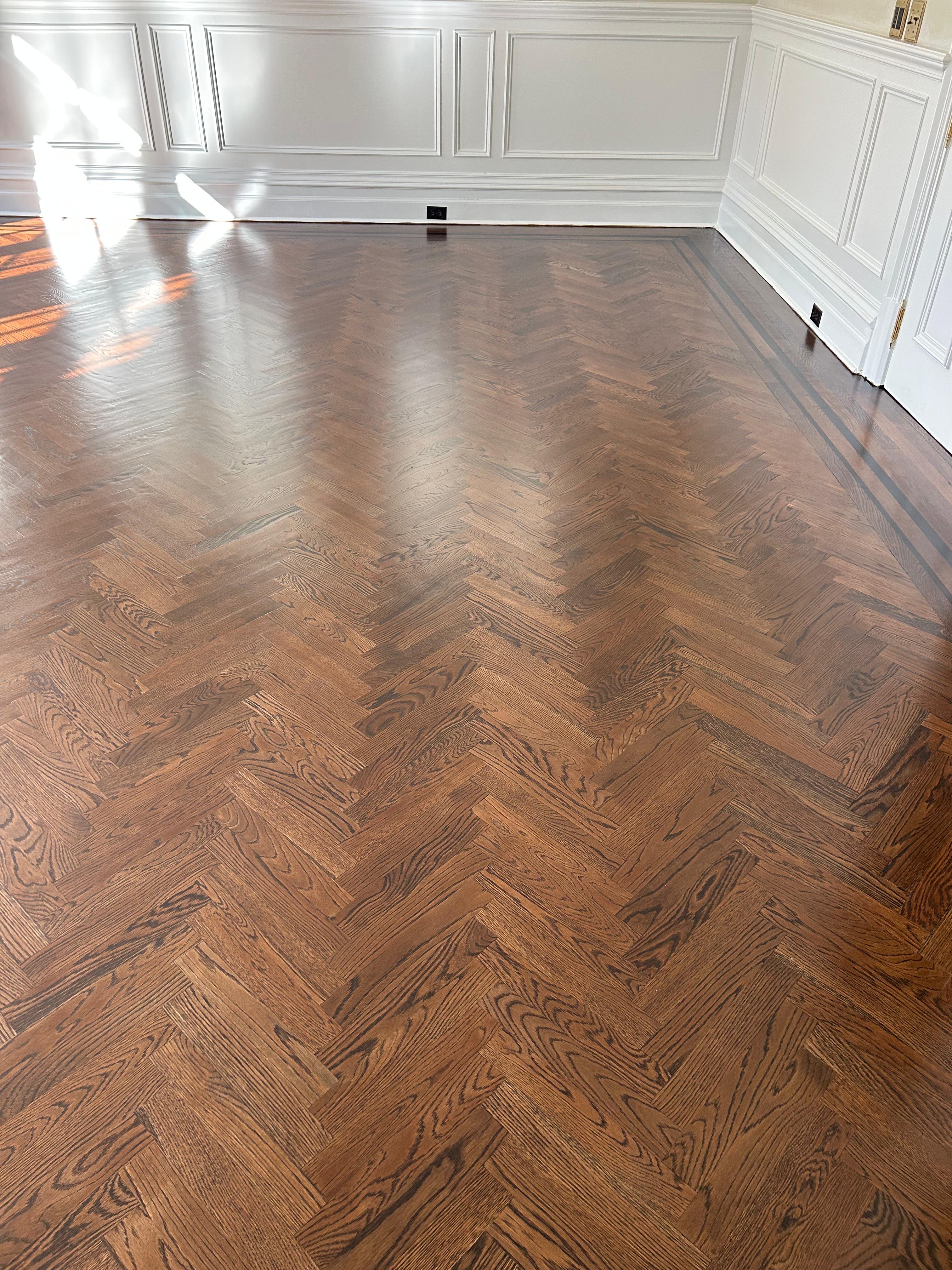 Dark oak herringbone parquet floor installation