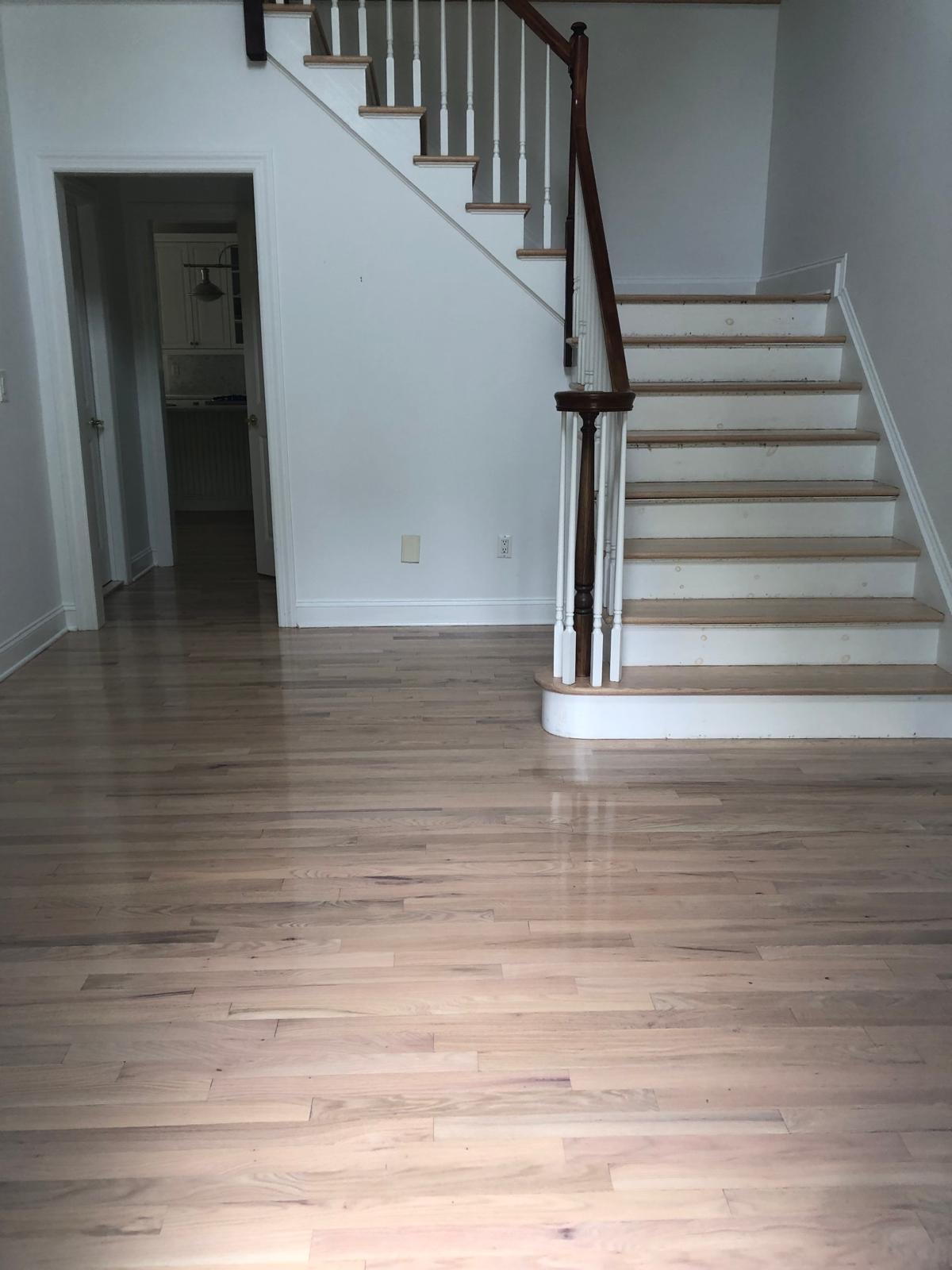Living room hardwood floor refinish with staircase